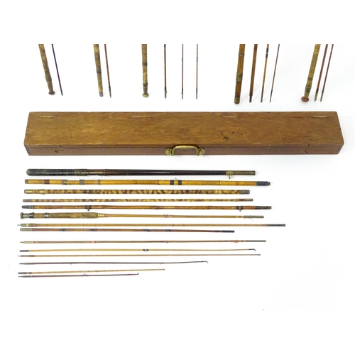 1305 - Fishing: a late 19thC fishing rod box , containing a quantity of split cane, bamboo and greenheart r... 