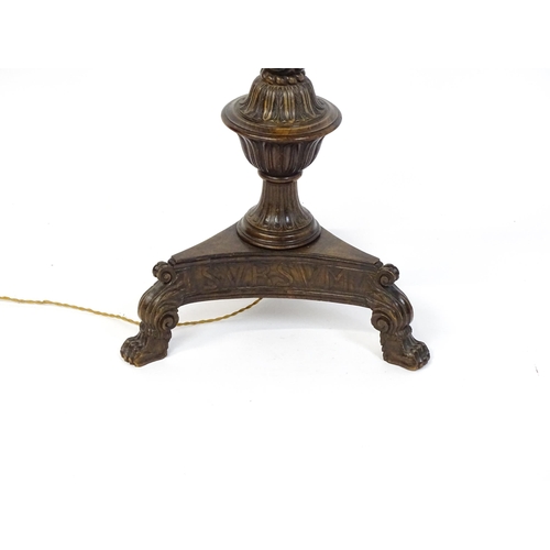 1555 - A mahogany carved and turned column standard lamp with triform base having scroll and paw feet. Appr... 