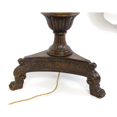 1555 - A mahogany carved and turned column standard lamp with triform base having scroll and paw feet. Appr... 