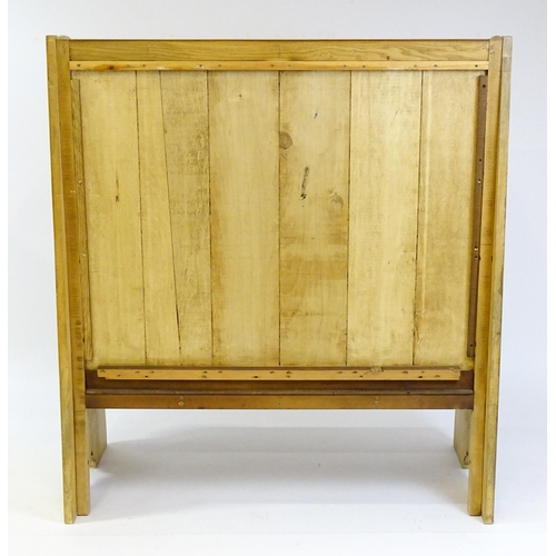 1579 - A late 20thC oak settle with a planked backrest flanked by wings and raised on shaped sides and a pl... 