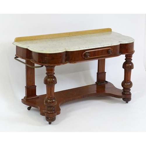 1580 - A Victorian mahogany washstand with a marble top above a single frieze drawer raised on turned, tape... 