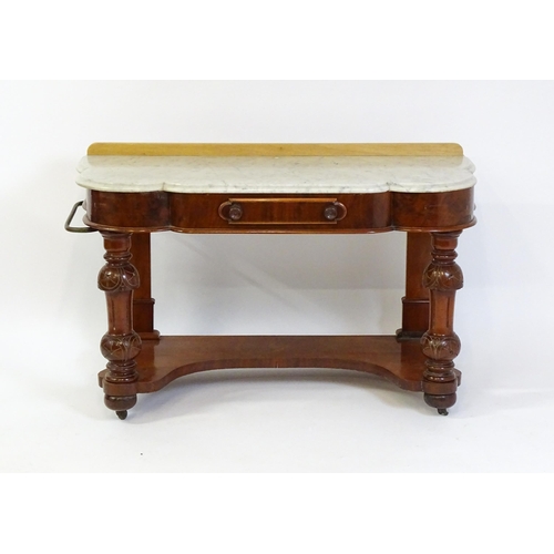 1580 - A Victorian mahogany washstand with a marble top above a single frieze drawer raised on turned, tape... 