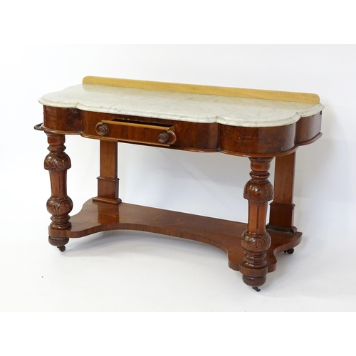 1580 - A Victorian mahogany washstand with a marble top above a single frieze drawer raised on turned, tape... 