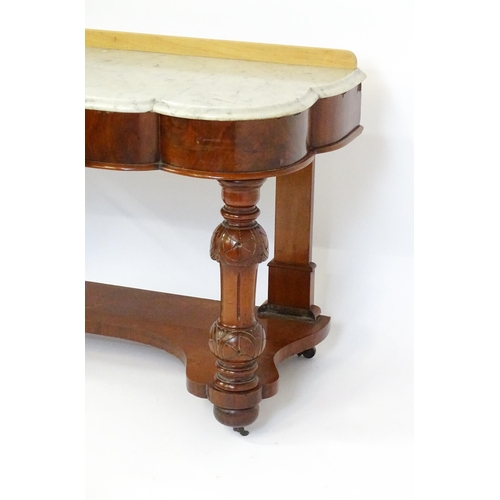 1580 - A Victorian mahogany washstand with a marble top above a single frieze drawer raised on turned, tape... 