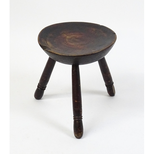 1754 - A 19thC Welsh milking stool raised on three turned tapering legs. 13