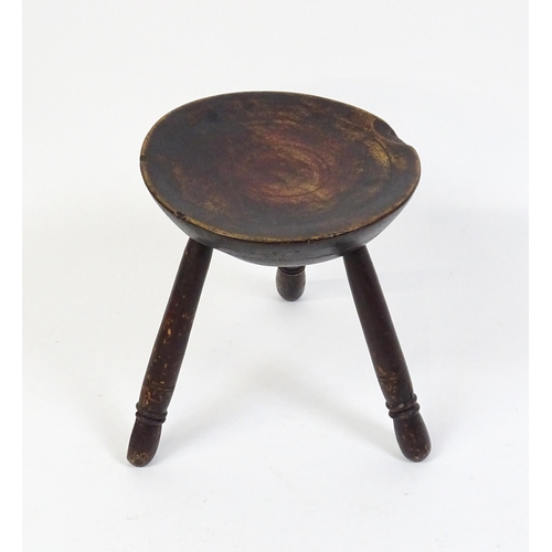 1754 - A 19thC Welsh milking stool raised on three turned tapering legs. 13