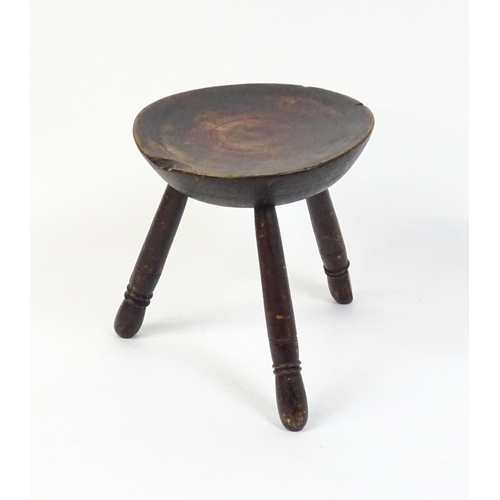 1754 - A 19thC Welsh milking stool raised on three turned tapering legs. 13