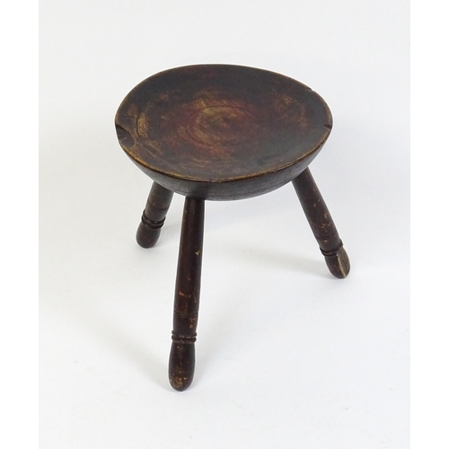 1754 - A 19thC Welsh milking stool raised on three turned tapering legs. 13