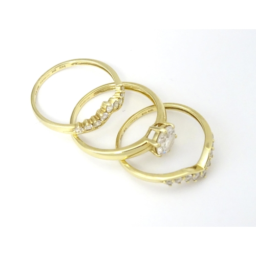 563 - Three 14ct gold rings set with white stones to be worn together. Ring size approx. R 1/2 (3)