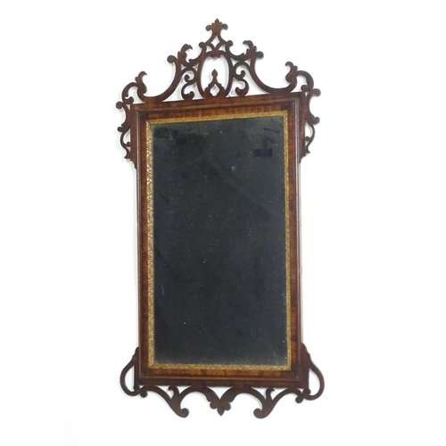 1557 - A late 18thC mahogany wall mirror with pierced fretwork and crossbanded detail. Approx. 39