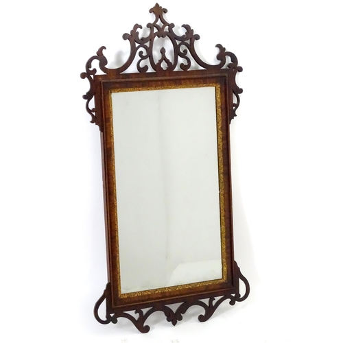 1557 - A late 18thC mahogany wall mirror with pierced fretwork and crossbanded detail. Approx. 39