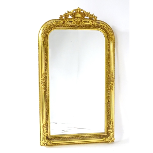 1701 - A modern mirror with a gilt and gesso frame surrounded by floral mouldings. 34