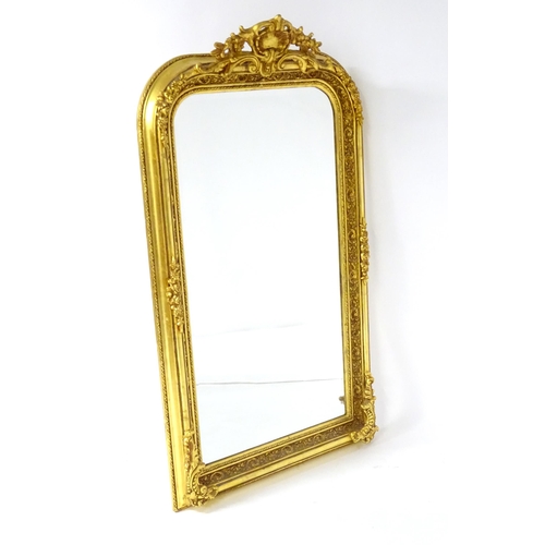 1701 - A modern mirror with a gilt and gesso frame surrounded by floral mouldings. 34