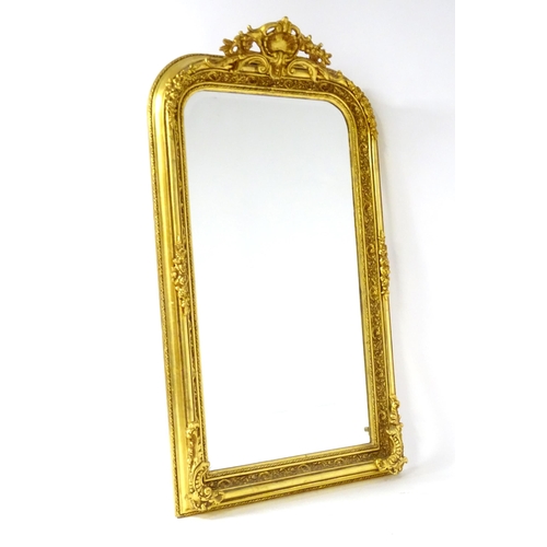 1701 - A modern mirror with a gilt and gesso frame surrounded by floral mouldings. 34