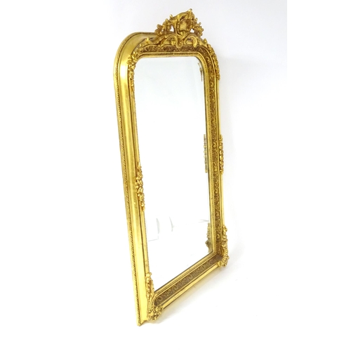 1701 - A modern mirror with a gilt and gesso frame surrounded by floral mouldings. 34