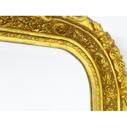 1701 - A modern mirror with a gilt and gesso frame surrounded by floral mouldings. 34