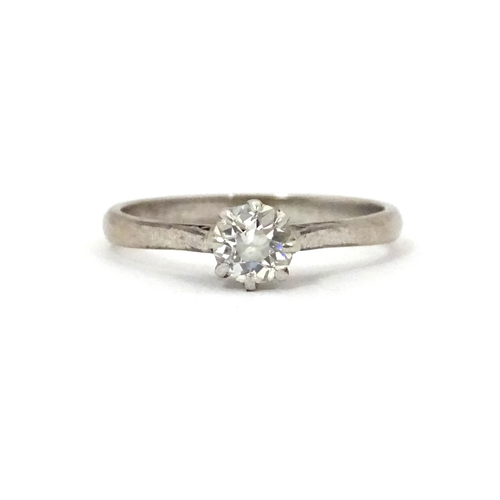 548 - An 18ct gold and platinum set brilliant cut diamond solitaire ring. Claw set diamond approx. 4mm dia... 