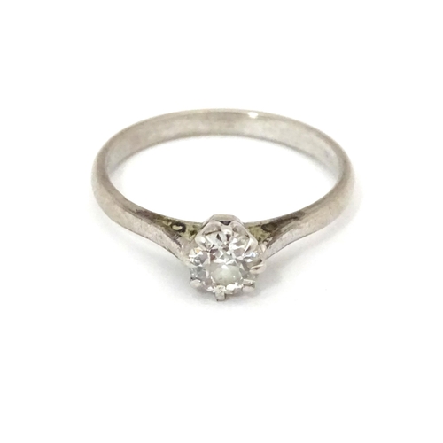 548 - An 18ct gold and platinum set brilliant cut diamond solitaire ring. Claw set diamond approx. 4mm dia... 