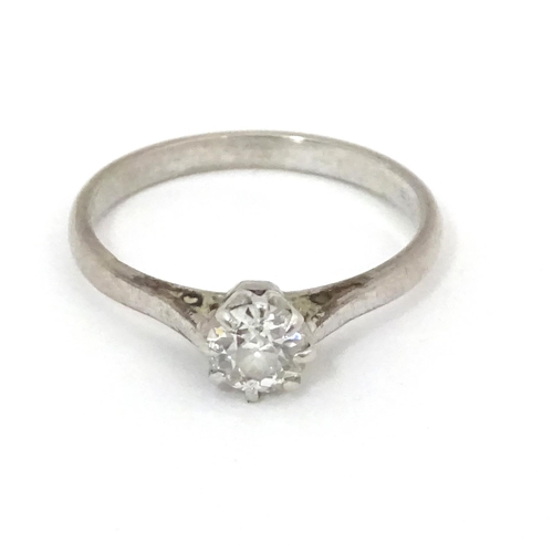 548 - An 18ct gold and platinum set brilliant cut diamond solitaire ring. Claw set diamond approx. 4mm dia... 