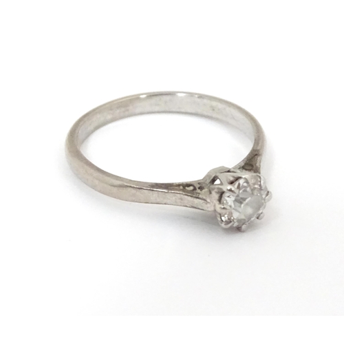 548 - An 18ct gold and platinum set brilliant cut diamond solitaire ring. Claw set diamond approx. 4mm dia... 