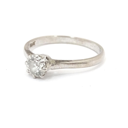 548 - An 18ct gold and platinum set brilliant cut diamond solitaire ring. Claw set diamond approx. 4mm dia... 