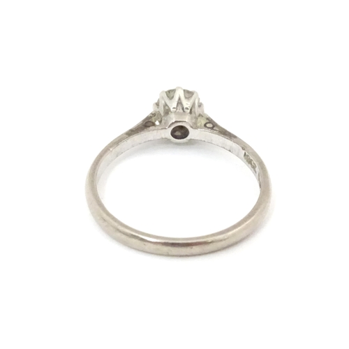 548 - An 18ct gold and platinum set brilliant cut diamond solitaire ring. Claw set diamond approx. 4mm dia... 