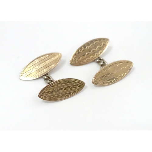 700 - A pair of white metal cufflinks with engraved decoration