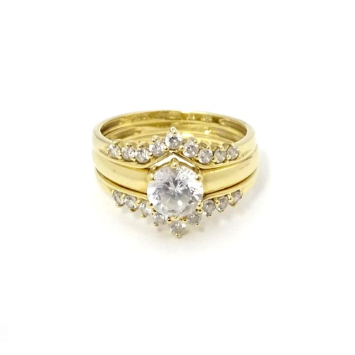 563 - Three 14ct gold rings set with white stones to be worn together. Ring size approx. R 1/2 (3)