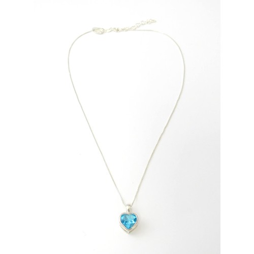 690 - A .925 silver pendant and chain, the pendant of heart form set with blue stone. Pendant approx. 1/2