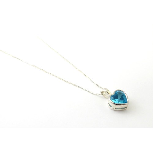 690 - A .925 silver pendant and chain, the pendant of heart form set with blue stone. Pendant approx. 1/2