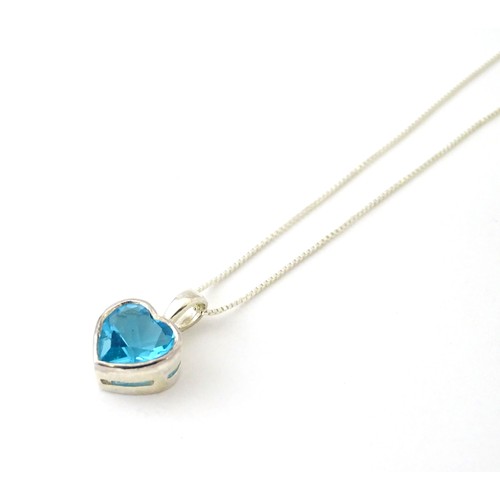 690 - A .925 silver pendant and chain, the pendant of heart form set with blue stone. Pendant approx. 1/2