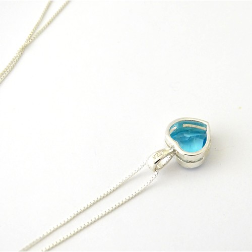 690 - A .925 silver pendant and chain, the pendant of heart form set with blue stone. Pendant approx. 1/2