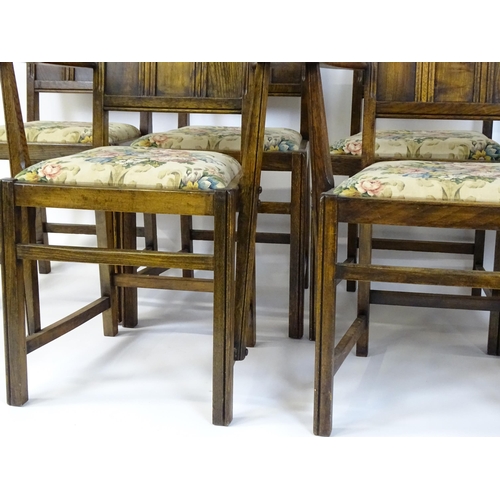 37 - A set of six early / mid 20thC oak and elm Gothic Ercol style dining chairs. The armchairs measuring... 