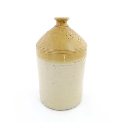 78 - An early 20thC two tone stoneware flagon marked James Pettit, Successor to Robert Dell Wine & Spirit... 