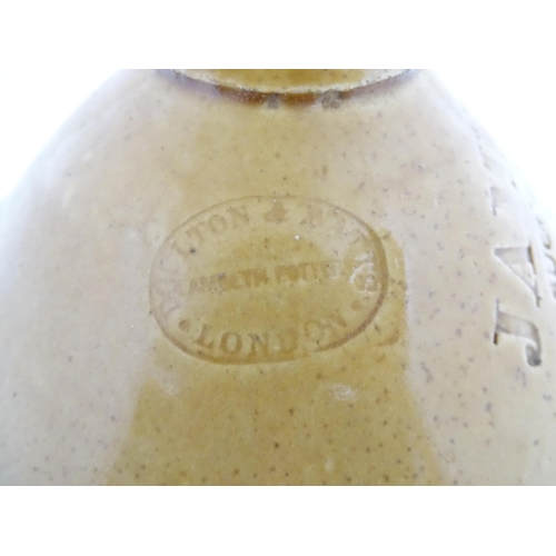 78 - An early 20thC two tone stoneware flagon marked James Pettit, Successor to Robert Dell Wine & Spirit... 