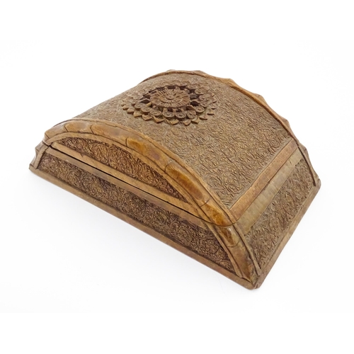 92 - A 20thC Anglo-Indian carved wooden cigar / cigarette box of dome form with engraved floral decoratio... 