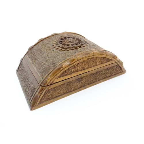 92 - A 20thC Anglo-Indian carved wooden cigar / cigarette box of dome form with engraved floral decoratio... 