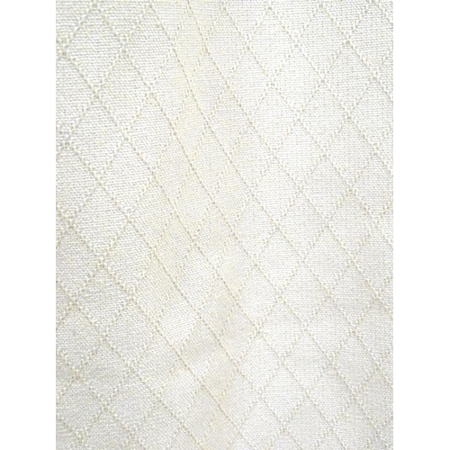 99 - A pair of curtains with a cream ground with lozenge detail. Approx. 45