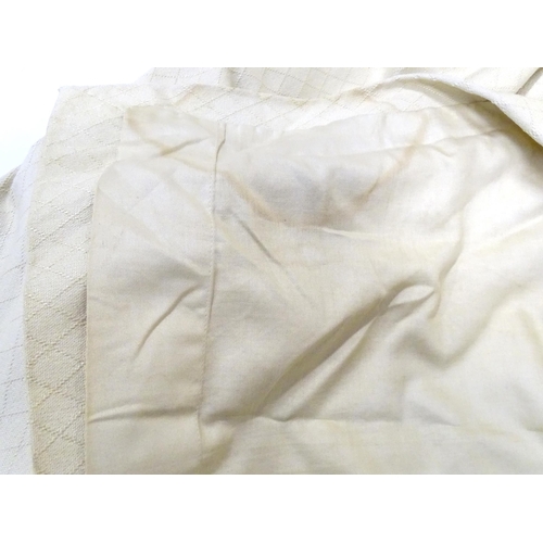 99 - A pair of curtains with a cream ground with lozenge detail. Approx. 45