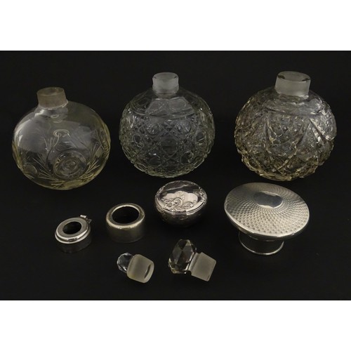 119 - Three assorted glass scent / perfume bottles, two with silver tops, Largest approx. 5