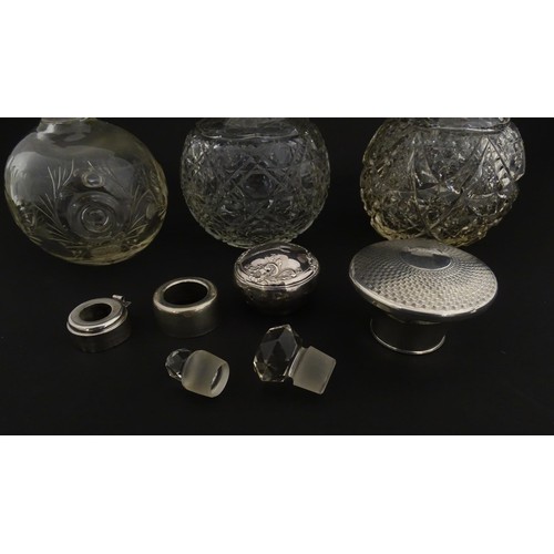 119 - Three assorted glass scent / perfume bottles, two with silver tops, Largest approx. 5