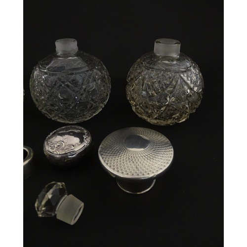 119 - Three assorted glass scent / perfume bottles, two with silver tops, Largest approx. 5