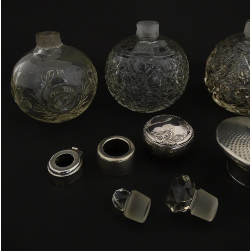 119 - Three assorted glass scent / perfume bottles, two with silver tops, Largest approx. 5