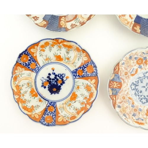 129 - Six assorted Japanese plates with scalloped edges decorated in the Imari palette with flowers and fo... 