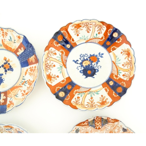 129 - Six assorted Japanese plates with scalloped edges decorated in the Imari palette with flowers and fo... 