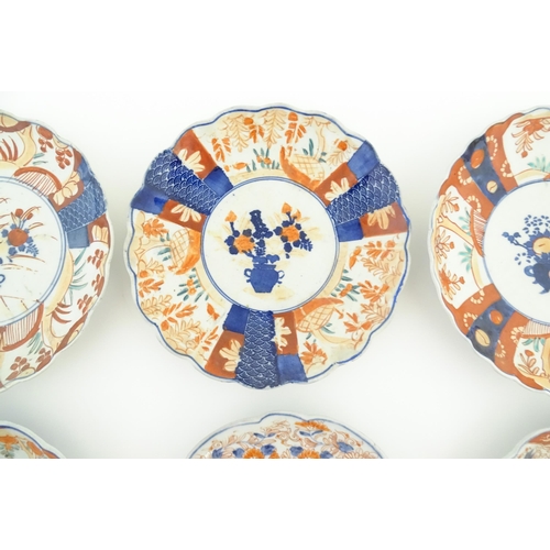 129 - Six assorted Japanese plates with scalloped edges decorated in the Imari palette with flowers and fo... 