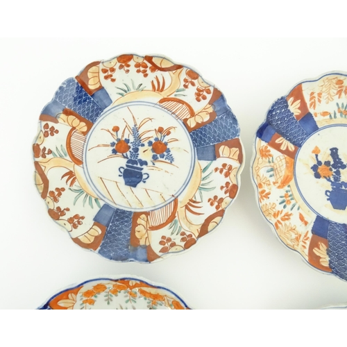 129 - Six assorted Japanese plates with scalloped edges decorated in the Imari palette with flowers and fo... 