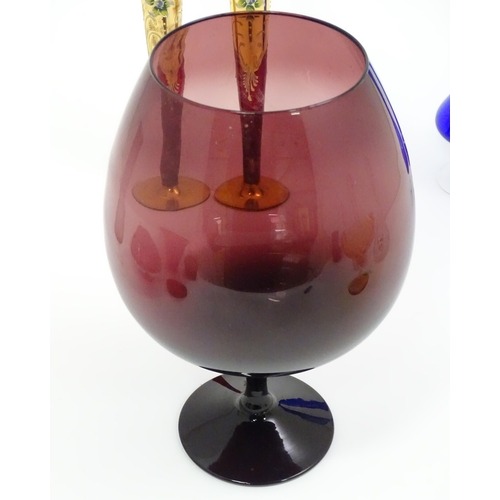 301 - A quantity of assorted glassware to include pedestal blue glass vases, candlesticks, decanters, pede... 