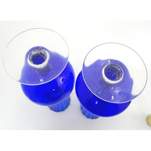 301 - A quantity of assorted glassware to include pedestal blue glass vases, candlesticks, decanters, pede... 