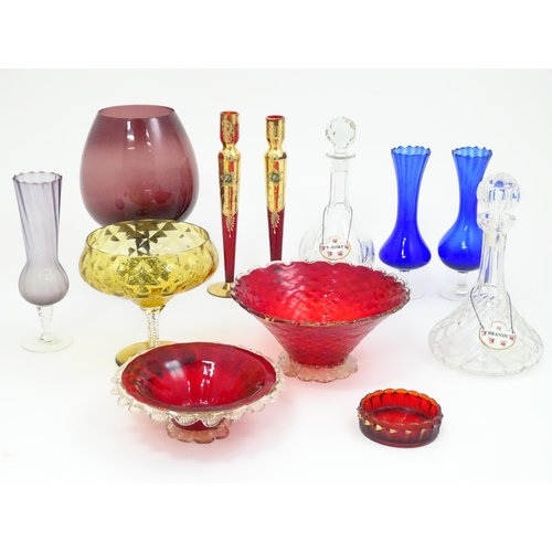 301 - A quantity of assorted glassware to include pedestal blue glass vases, candlesticks, decanters, pede... 